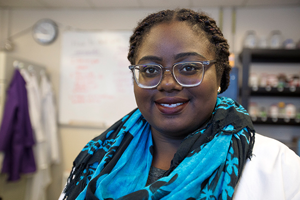 smiling woman managing work in a laboratory