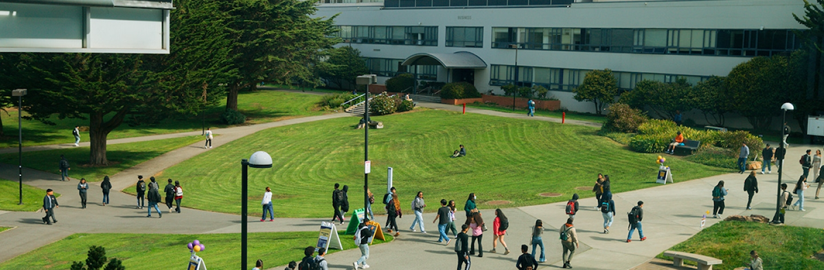 SFSU Campus with students walking around and Business Building in the background