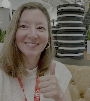Katrina Parker headshot in a building lobby with stack of Oreo cookies sculpture in the backgroung