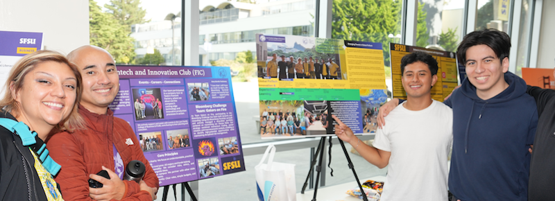 LFCoB Research and Innovation Showcase, 4 students showing their research presentation posters